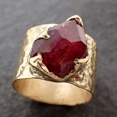 Partially Faceted Ruby Sapphire / Cigar Band / Cocktail / Statement ring I created this setting in wax then cast it in recycled 18k gold at my home studio. This lovely Sapphire ring is a size 7. The stone measures about 10mm X 13mm. The band is around 12mm wide. Throughout all time and history in every tribe and culture all around the world crystals, minerals and gemstones have used for healing, luck, divination, adornment vibrational medicine and so much more. Sapphire is a stone for mental cla Luxury Handmade Antique Ruby Ring, Unique Untreated 14k Gold Jewelry, Hand Forged Ruby Ring Jewelry, Hand Forged Ruby Ring For Anniversary, Untreated Fine Jewelry For Anniversary, Yellow Gold Jewelry With Gemstone In Wide Band, Yellow Gold Wide Band Jewelry With Gemstone, Anniversary Ruby Rings Hand Forged, Anniversary Hand Forged Ruby Rings