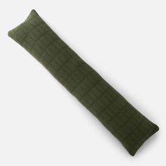 a green pillow on a white background