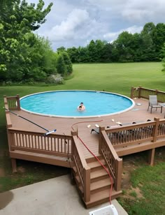 an above ground swimming pool with steps leading up to it and a person in the water