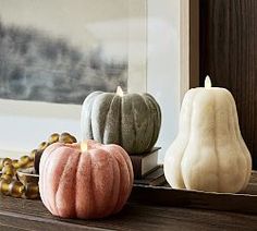 three decorative pumpkins sitting on top of a window sill next to each other