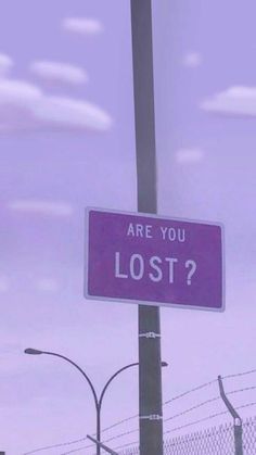 a purple sign that says are you lost? on the side of a street pole