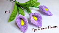 three crocheted purple flowers with green stems and yellow centers on white background text reads diy pipe cleaner flowers