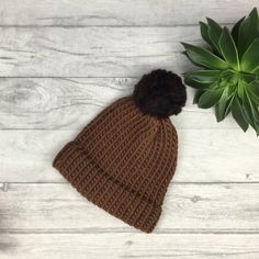 Our tonal brown knitted hat is made from 100% merino wool which is known for being super soft, warm and long lasting.  We choose wool as it is so durable and a natural product. At the end of its life, it is biodegradable.  We believe in beautiful, practical and long lasting items which are unique, a joy to own and will be treasured for many years to come.  - Chocolate and Hazelnut brown  - Designed to fit snug to your head - 100% wool  - Available with or without a pom pom  - Pom pom (if requested) will be in hazelnut brown  - Gift wrapped  || Sizes || Tiny baby - From birth, this is suitable for smaller and premature newborn babies.  0-3 months - From birth to 3 months old  3-6 months - From approximately 3 months old to 6 months and beyond 6 months - 12 months - This hat will adapt to yo Solid Knit Beanie Hat, Classic Knit Beanie Hat, Classic Knitted Beanie For Cold Weather, Solid Warm Wool Beanie, Winter Wool Crochet Beanie Hat, Classic Knitted Merino Wool Beanie, Warm Knit Hat In Solid Color, Classic Knit Hats For Cold Weather, Solid Color Crochet Hat For Cold Fall Weather