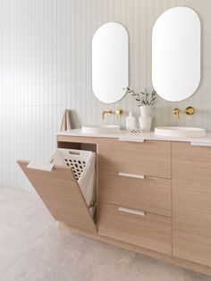 a bathroom with two mirrors and double sinks