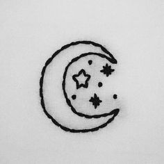 a black and white drawing of a crescent with stars on it