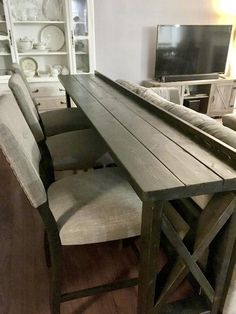 a wooden table with chairs around it