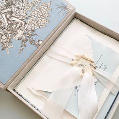 an open box with some white ribbons in it