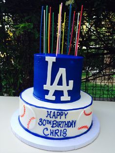 a birthday cake with candles in the shape of a los angeles dodgers baseball team's number