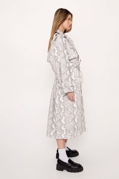 Layer up. Feel wild in our trench coat, with an iconic snake print and a relaxed, open design, and a belted waist fastening for a stellar silhouette. Pairs well with jeans for an elevated daytime look, or wear it over a mini dress for a levelled up night out look. Petite Premium Snake Print Trench Coat Head Turning Snake Print Iconic Longline Cut Sleek, Open Design Belted Waist for a Cinched Silhouette Model wears a size M (US size 6/UK size 10). Petite Trench Coat, Petite Coat, Oasis Fashion, Open Design, Petite Outfits, Fashion Face, Snake Print, Long A Line, Nice Dresses