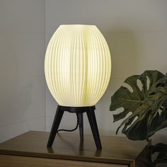 Our wavy 3D printed table lamp sits just shy of 17" tall and brings a modern touch to a variety of rooms. The three-legged base paired with its transitional style shade make for an eye-catching design. With an in-line dimmer switch, this lamp can set any mood. JONATHAN Y Wavy Contemporary Plant 3D Printed Lamp 16.5-in White/Black LED Table Lamp with Plastic Shade | USA1000A Wavy Table, Modern Style Bedroom, Minimalist Table, Table Lamp White, Minimalist Tables, Wavy Design, Fixture Table, High Table, Green Led