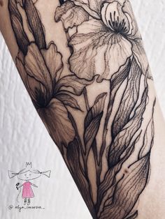 a woman's arm with flowers on it