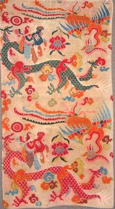 an old chinese rug with dragon and flowers on it