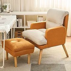 an orange chair and ottoman sit in front of a white desk