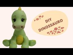 a small green toy sitting on top of a white table next to a sign that says diy dinosauro