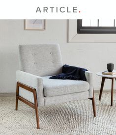 a chair and table in front of a window with the words article written on it