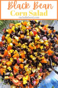 corn salad with black beans and carrots in a glass bowl on top of a table