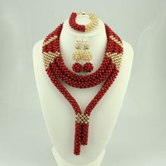 a red beaded necklace with matching earrings