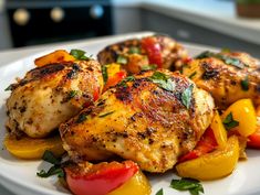 chicken and bell peppers on a white plate