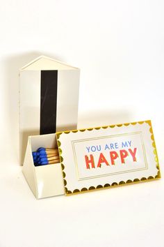 an open box containing matches and a card that says you are my happy