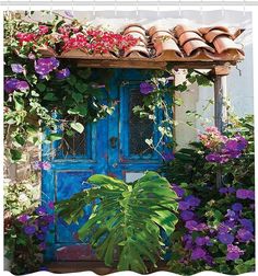 a blue door surrounded by purple flowers and greenery