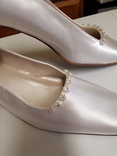 "Beautiful elegant pump style shoes, for the minimalist bride who loves chic shoes! HEEL square, as shown in white: 1 1/2\" If, you prefer the champagne pictured heels (up to size 12, 12W) please click on link below: www.etsy.com/listing/703287418/gold-pump-shoesgolden-anniversary? Please look at the pictures for details such as the gold tone bling brooches adding a very special Elegant & Chic touch. COLOR AVAILABLE: Champagne, Silver, White, Off-White, Ivory SIZES AVAILABLE: M (Medium width Elegant White Flat Heel Court Shoes, Elegant White Court Shoes With Flat Heel, Classic Cream Closed Toe Wedding Shoes, Elegant Cream Kitten Heels With Closed Toe, Elegant Cream Closed Toe Kitten Heels, Classic Cream Almond Toe Wedding Shoes, Classic Closed Toe Wedding Court Shoes, Classic Flat Heel Wedding Shoes, Classic Closed Toe Court Shoes For Wedding