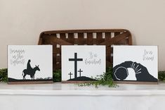 three cards with animals on them sitting on a mantle