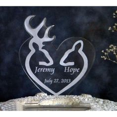 an acrylic heart with the name and image of two deers on it