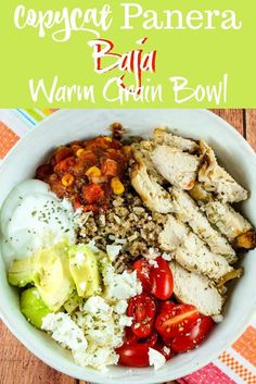 a bowl filled with meat, vegetables and rice on top of a checkered table cloth