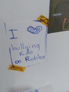 a white refrigerator freezer covered in magnets and paper with writing on the door