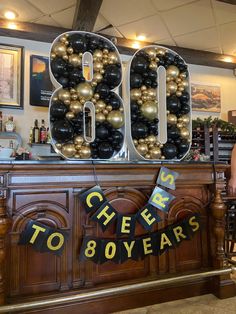 a man standing in front of a sign that says 80 years to 80 years on it