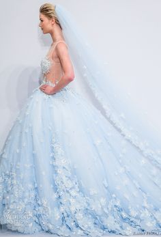 a woman in a blue wedding dress with flowers on it