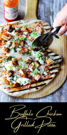 a person is cutting pizza on a wooden board with a spatula and sauce in the background