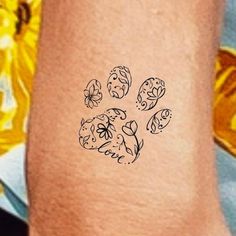 a dog's paw with flowers and leaves on the left side of his leg