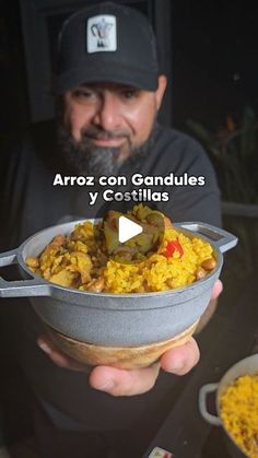 a man holding a bowl full of food with the caption arroz con gandules y costillas