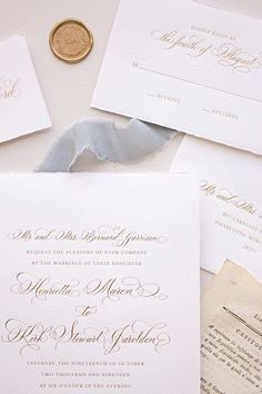 the wedding stationery is laid out on top of each other with a wax seal