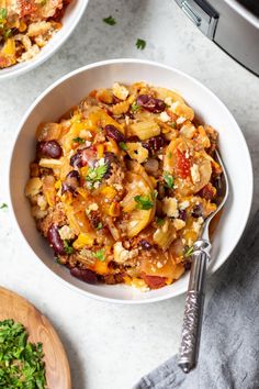 two bowls filled with food sitting on top of a table