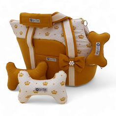 a stuffed dog is sitting next to a diaper bag and its matching bone toy