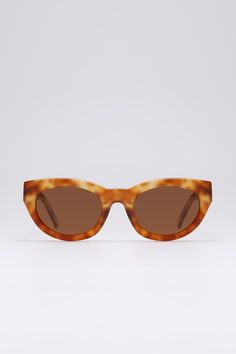 Frame: Brown tortoiseshell acetate Lenses: Brown Lenses: 52 mm, Bridge: 22 mm, Temples: 150 mm Brown tortoiseshell-acetate sunglasses shaped to an elegant cat-eye silhouette, offering a mix of functionality and retro elegance. They're made with brown tinted lenses for good UV protection.