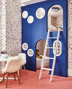 a child's bedroom with a bunk bed and colorful wallpapers on the walls