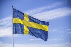 the swedish flag is flying high in the sky