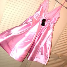 a pink dress hanging on a clothes line