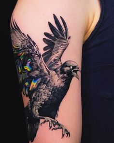 a woman's arm with a bird tattoo on it