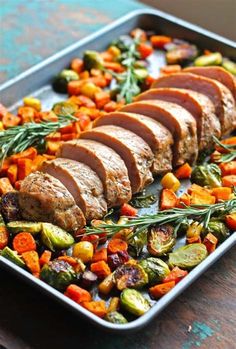 meat and vegetables on a platter ready to be cooked in the oven for dinner