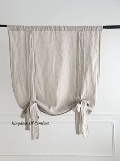 the curtain is hanging on a rod with two tassels attached to it's sides