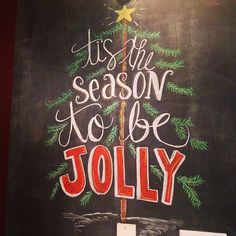 a chalkboard sign with the words tis'n season to be jolly written on it