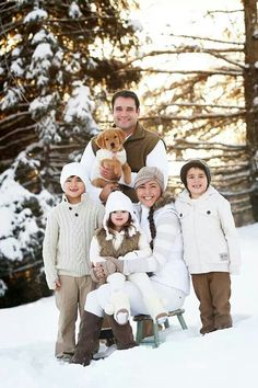 a family poses for a photo in the snow