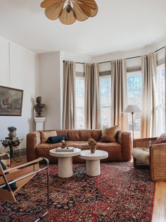 a living room filled with furniture and large windows