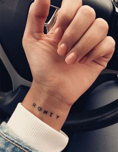 a person with a small tattoo on their wrist