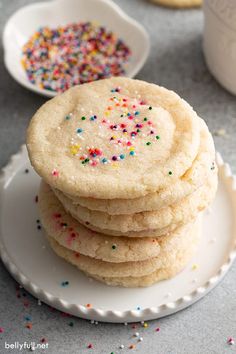 a stack of sugar cookies with sprinkles on a plate