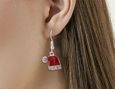 These Christmas-inspired Santa Hat earrings feature a 1/2" x 1/2" size, red and clear cz's and a classic fishhook style. Stylish and charming, these earrings are sure to be a holiday hit. Beachy Anklets, Celebrity Style Jewelry, Funny Sweater, Christmas Santa Hat, Flamingo Earrings, Cartilage Jewelry, Piercing Aftercare, Christmas Bracelet, Nose Hoop